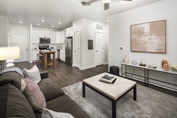 Spacious living room with modern decor in Tapestry at Brentwood Town Center Apartments