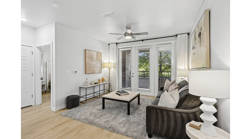Spacious living room with modern decor in Tapestry at Brentwood Town Center Apartments
