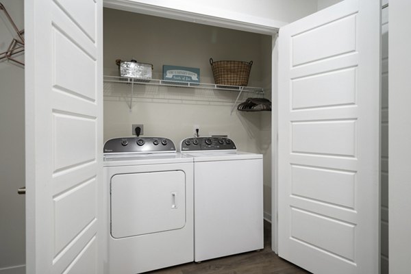 Laundry room with modern appliances at Tapestry at Brentwood Town Center Apartments