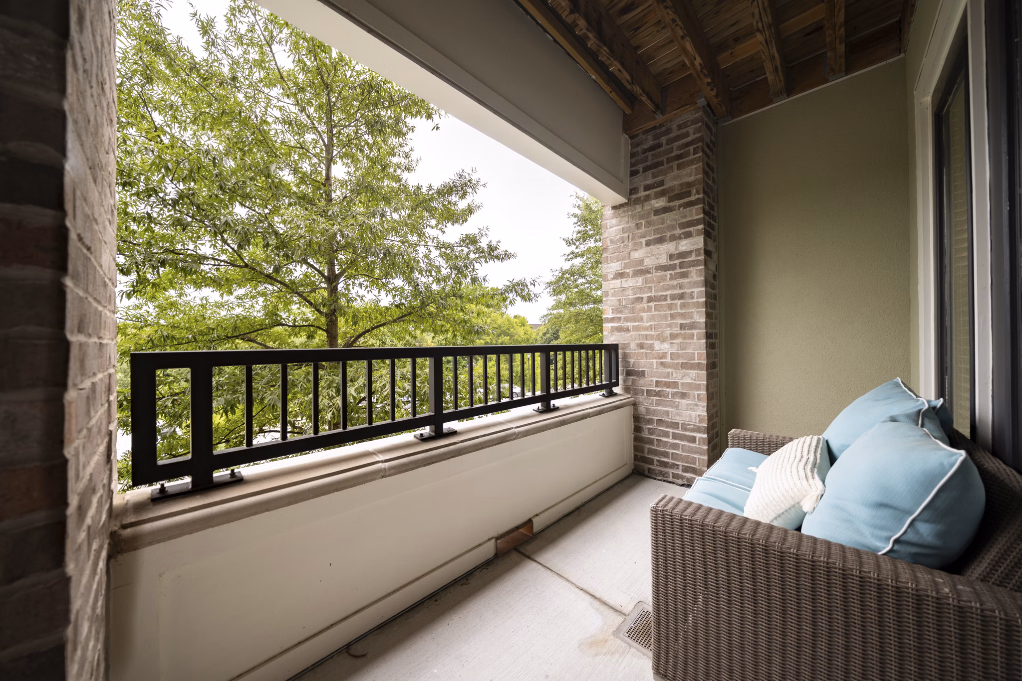 Patio at Tapestry at Brentwood Town Center Apartments featuring stylish outdoor seating and lush landscaping