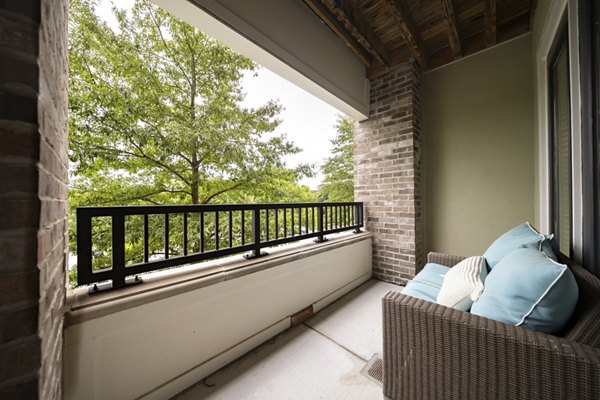 Patio at Tapestry at Brentwood Town Center Apartments featuring stylish outdoor seating and lush landscaping