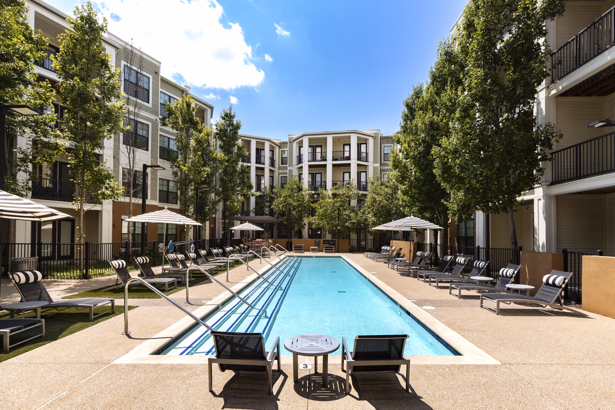 Relaxing outdoor pool area at Tapestry at Brentwood Town Center Apartments