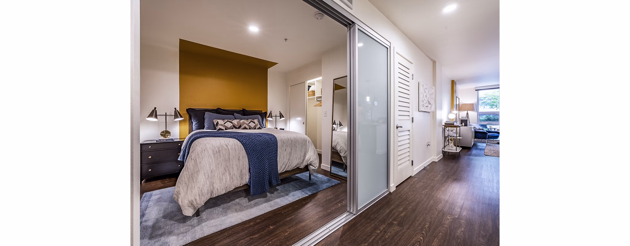 Cozy bedroom with modern furnishings at Elara at the Market Apartments