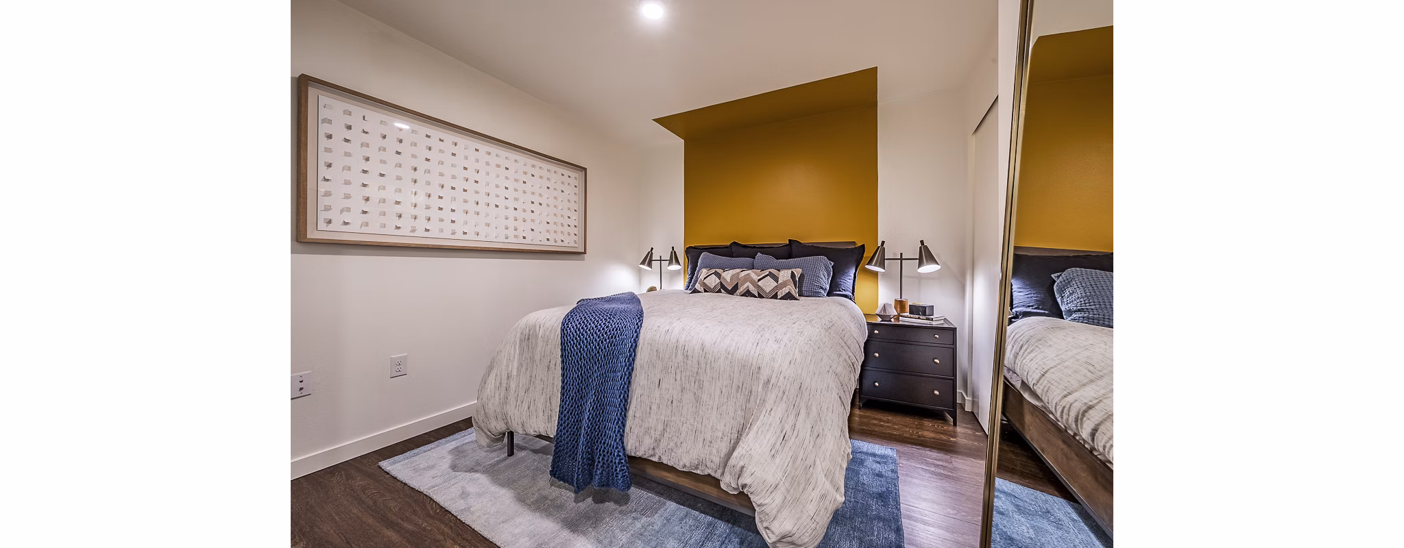 Chic bedroom with sleek design and ample natural light in Elara at the Market Apartments, a luxury residence by Greystar