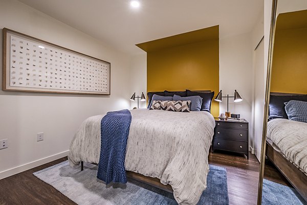 Chic bedroom with sleek design and ample natural light in Elara at the Market Apartments, a luxury residence by Greystar