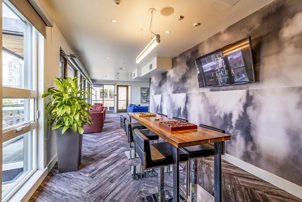 Stylish clubhouse with cozy seating at Elara at the Market Apartments, perfect for social gatherings and relaxation in modern luxury