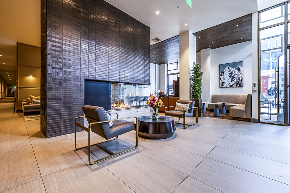 Clubhouse lobby featuring modern furnishings and cozy seating at Elara at the Market Apartments