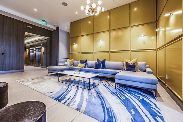 Modern clubhouse lobby featuring stylish seating and art at Elara at the Market Apartments