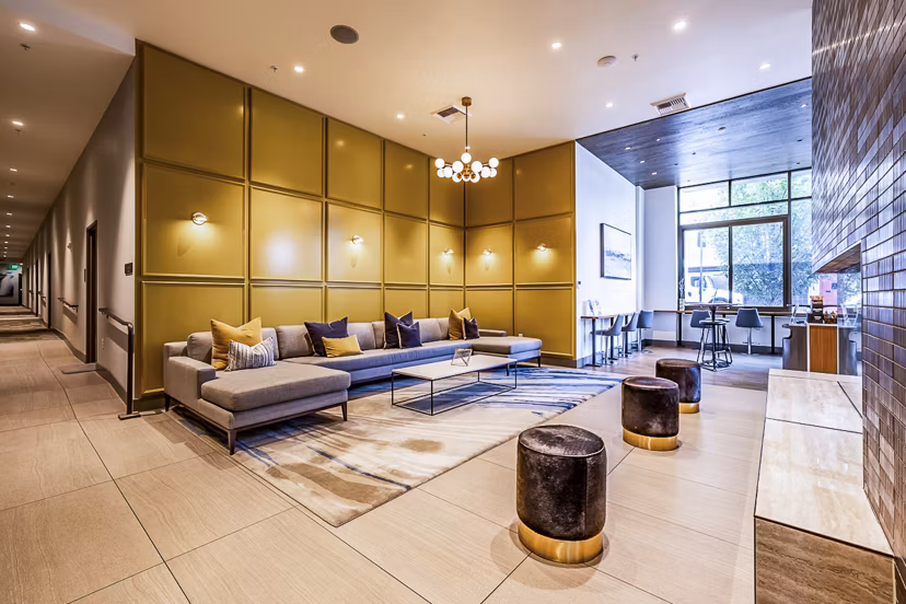 Clubhouse lobby with modern furnishings at Elara at the Market Apartments, featuring sleek dÃ©cor and spacious seating areas