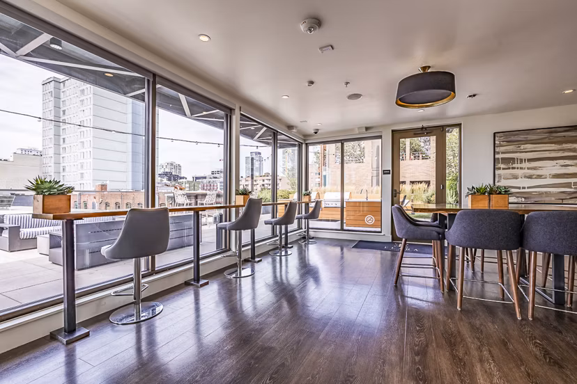 Modern clubhouse featuring stylish seating and game area at Elara at the Market Apartments