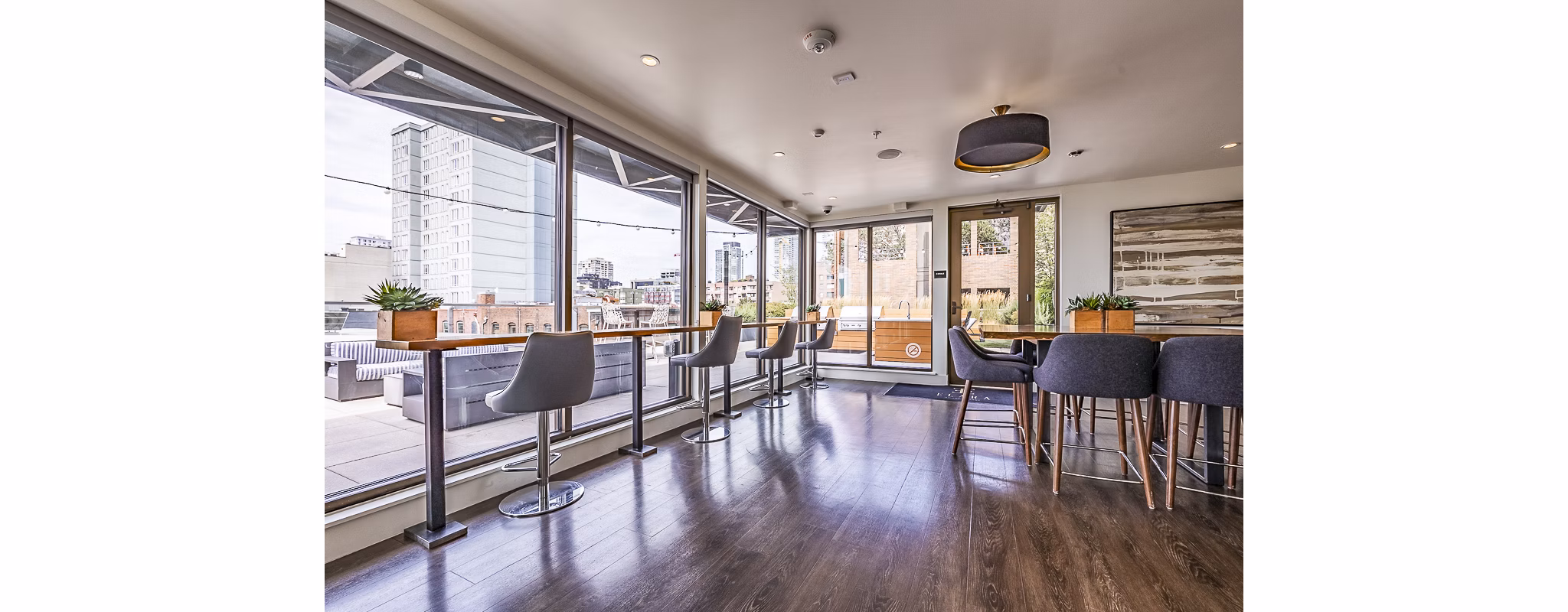 Modern clubhouse featuring stylish seating and game area at Elara at the Market Apartments