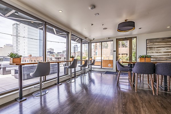 Modern clubhouse featuring stylish seating and game area at Elara at the Market Apartments