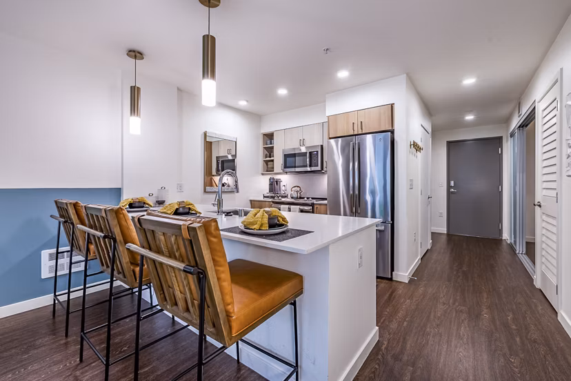 Modern kitchen with stainless steel appliances at Elara at the Market Apartments