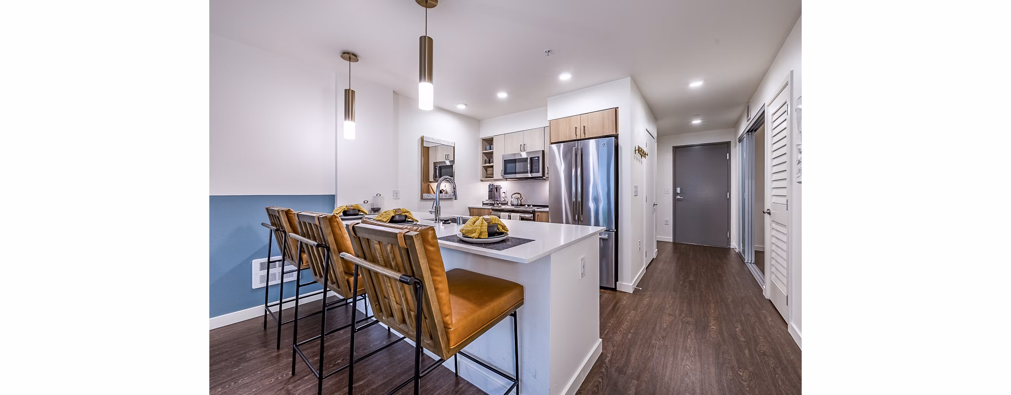 Modern kitchen with stainless steel appliances at Elara at the Market Apartments