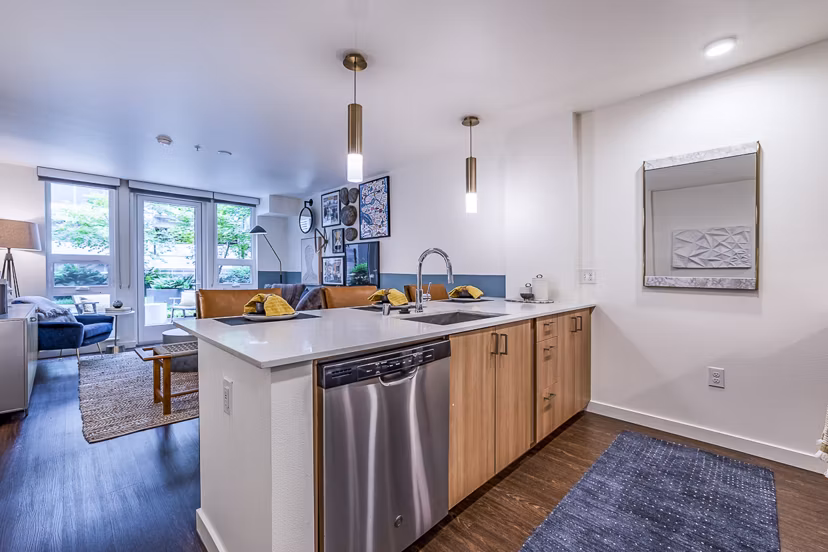 Modern kitchen with stainless steel appliances at Elara at the Market Apartments, offering sleek design and functionality for luxury living