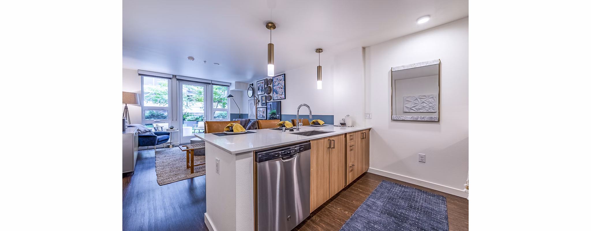 Modern kitchen with stainless steel appliances at Elara at the Market Apartments, offering sleek design and functionality for luxury living