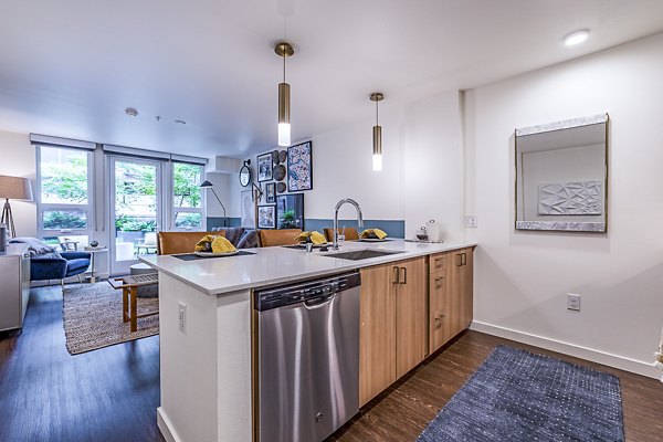 Modern kitchen with stainless steel appliances at Elara at the Market Apartments, offering sleek design and functionality for luxury living