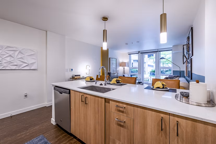 Modern kitchen with stainless steel appliances in Elara at the Market Apartments