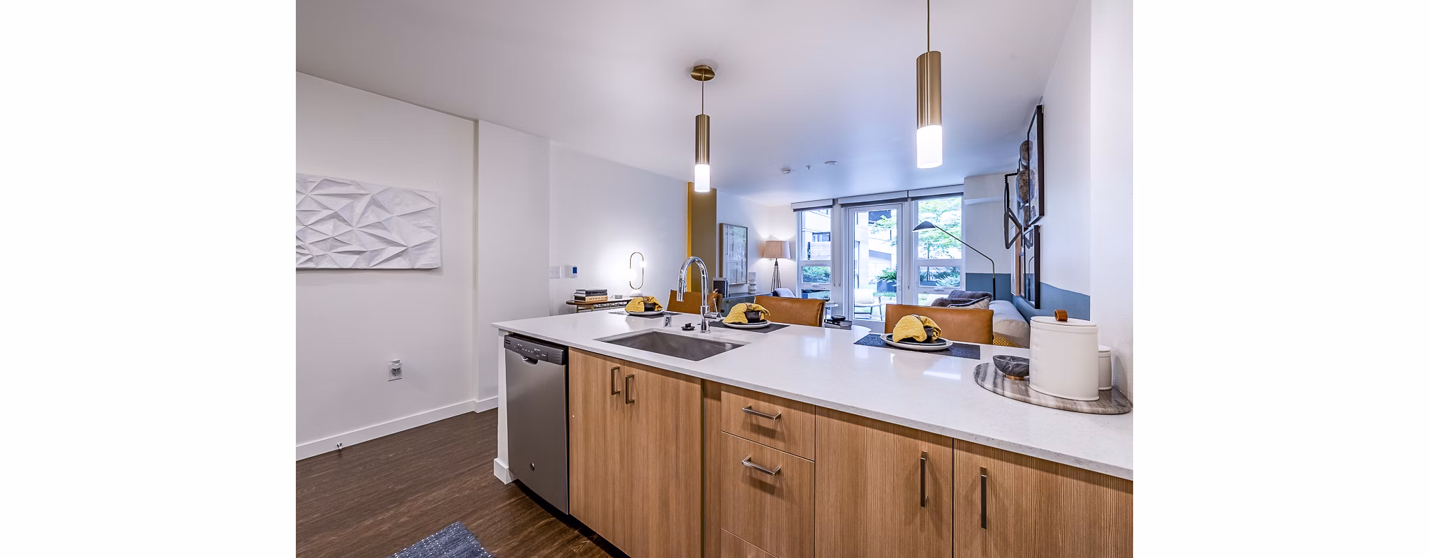 Modern kitchen with stainless steel appliances in Elara at the Market Apartments
