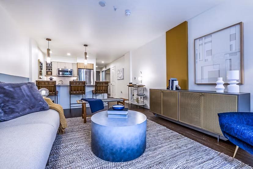 Spacious living room with modern decor at Elara at the Market Apartments