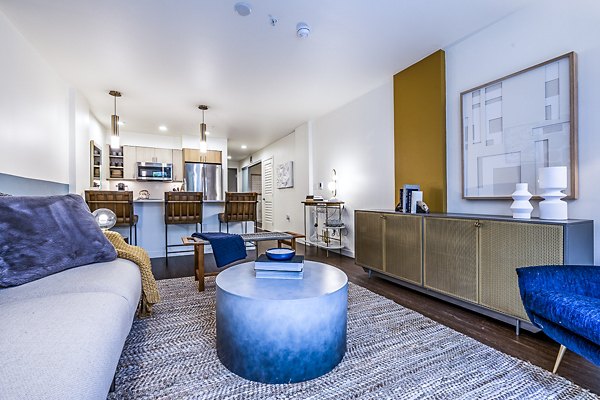 Spacious living room with modern decor at Elara at the Market Apartments