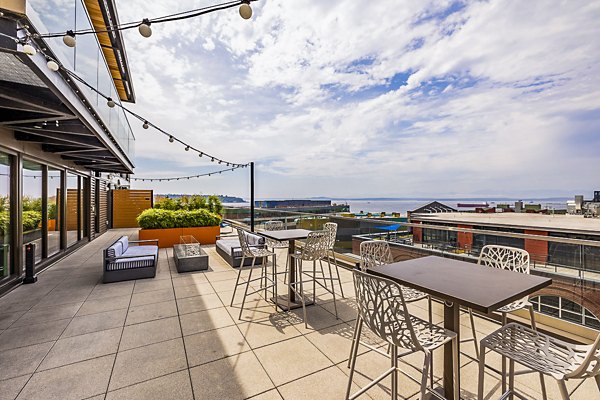 Elara at the Market Apartments: Cozy patio with modern outdoor furniture and city views