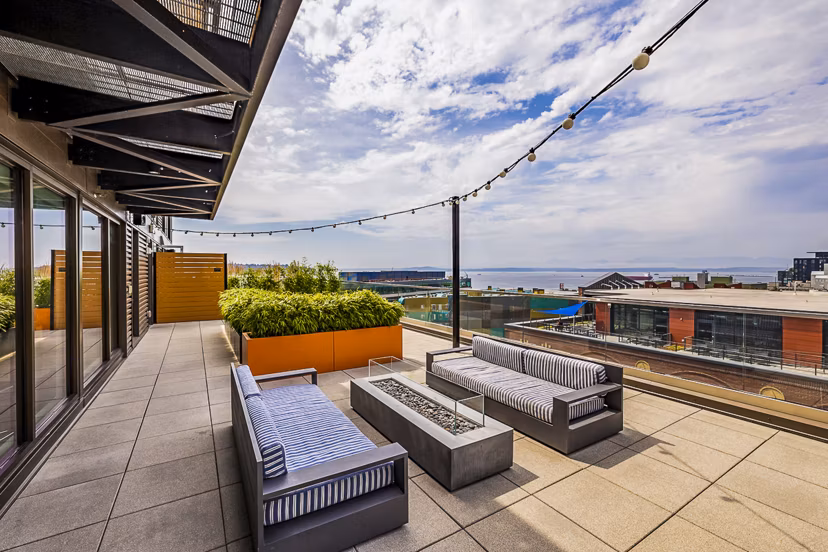 Patio with stylish seating at Elara at the Market Apartments, ideal for relaxation and entertainment, offering views of Market Street