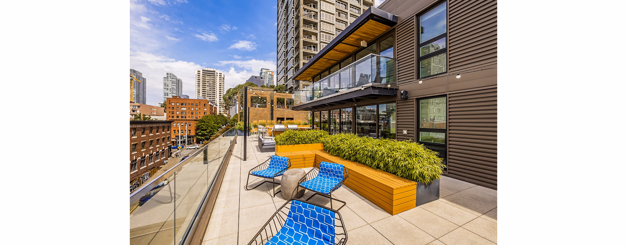 Private balcony with seating and lush views at Elara at the Market Apartments, Seattle's luxury housing option