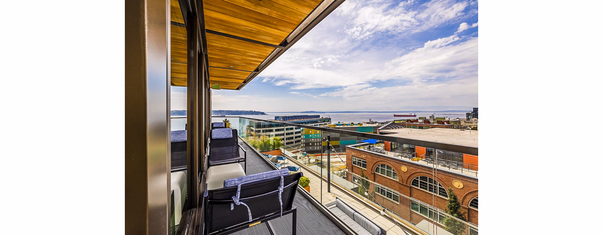 Cozy patio with outdoor seating at Elara at the Market Apartments, ideal for relaxation and city views