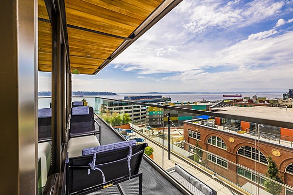 Cozy patio with outdoor seating at Elara at the Market Apartments, ideal for relaxation and city views