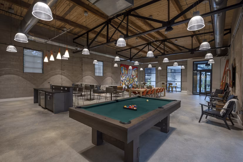 Enjoy a fully equipped game room with pool tables and arcade games at Bancroft Lofts luxury apartments