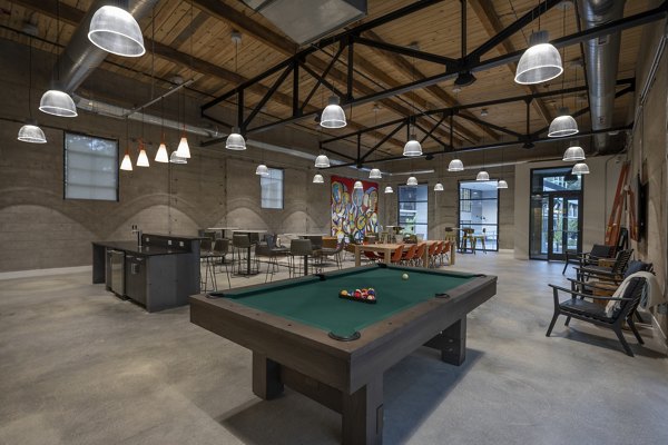 Enjoy a fully equipped game room with pool tables and arcade games at Bancroft Lofts luxury apartments