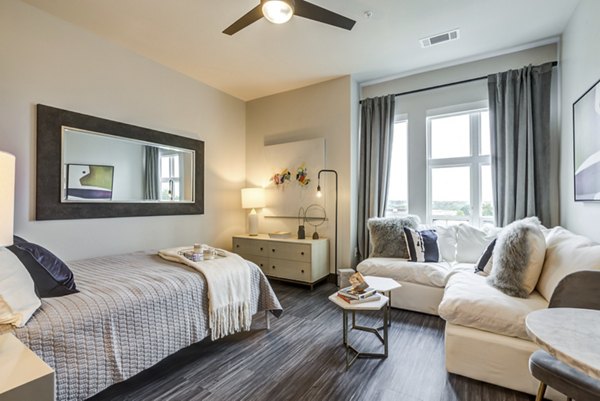 Bedroom with modern decor and ample natural light at Centro Railyard Apartments