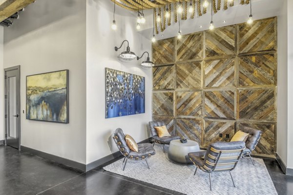 Clubhouse featuring modern design and comfortable seating at Centro Railyard Apartments, ideal for social gatherings and community events