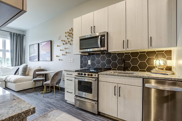 Modern kitchen with stainless steel appliances at Centro Railyard Apartments, a luxury Greystar community