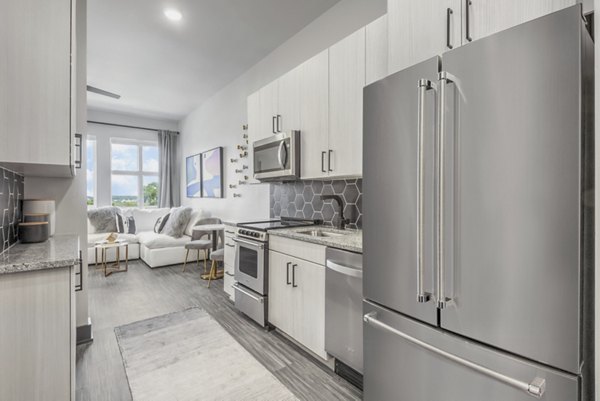 Centro Railyard Apartments: Modern kitchen with sleek countertops and stainless steel appliances