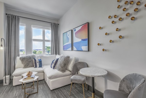 Living room with sleek furniture and artwork in Centro Railyard Apartments, offering a luxurious Greystar experience in a vibrant urban setting