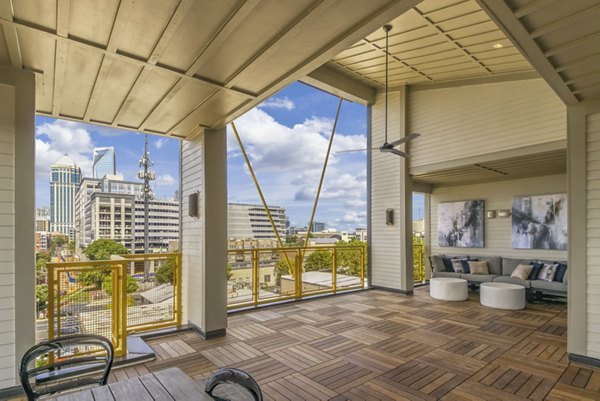 Modern patio area with seating and greenery at Centro Railyard Apartments