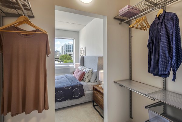 Walk-in closet with ample storage space at The Hamilton I Apartments, offering luxury living by Greystar in an elegant setting