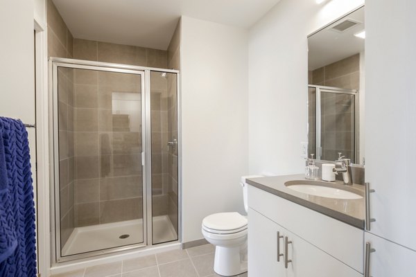 Guest bathroom featuring modern decor and sleek fixtures in The Hamilton I Apartments