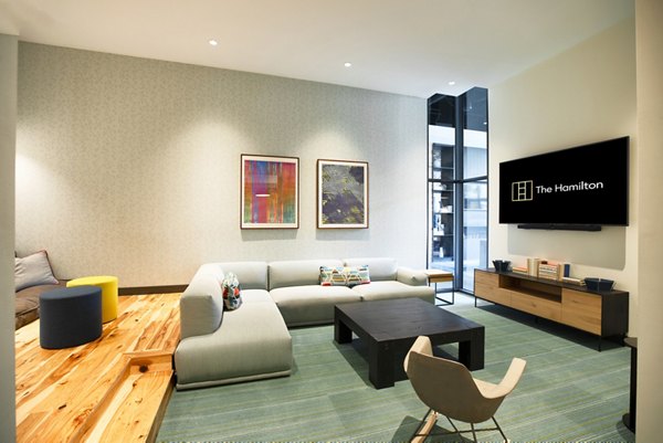 Modern theater room with plush seating at The Hamilton I Apartments