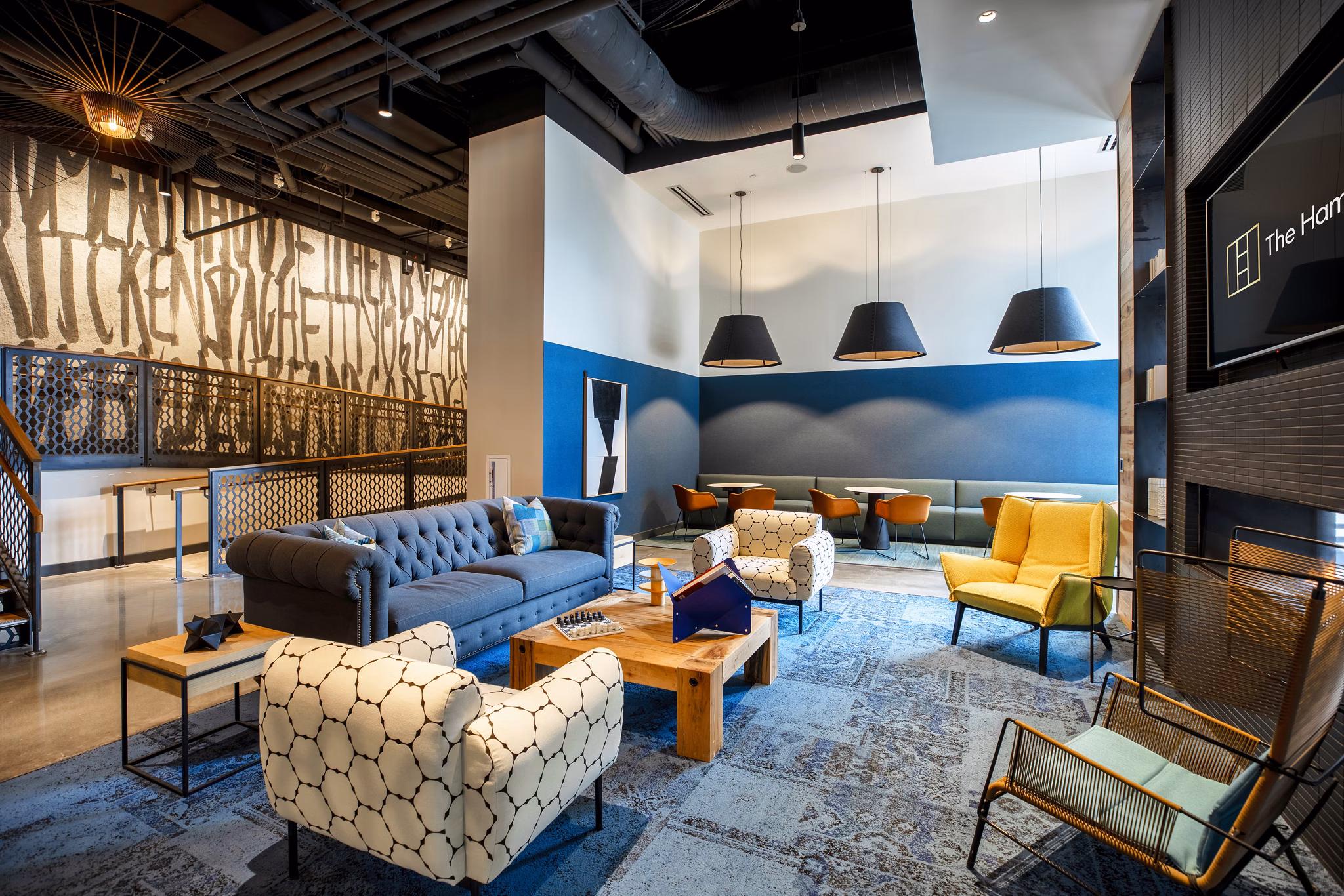 Spacious clubhouse featuring modern design and cozy seating at The Hamilton I Apartments, perfect for gatherings and events
