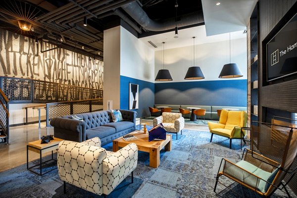Spacious clubhouse featuring modern design and cozy seating at The Hamilton I Apartments, perfect for gatherings and events