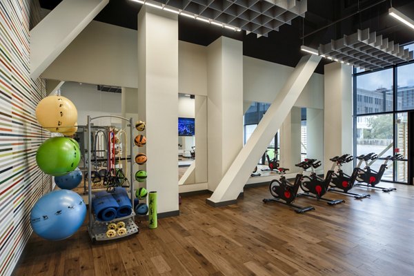 Yoga and spin studio at The Hamilton I Apartments with modern equipment and spacious design for fitness enthusiasts