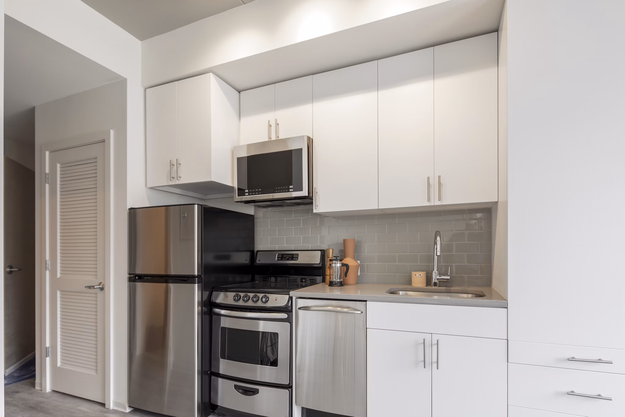 Modern kitchen with stainless steel appliances at The Hamilton I Apartments, luxury living in city center Perfect for culinary creations and gatherings