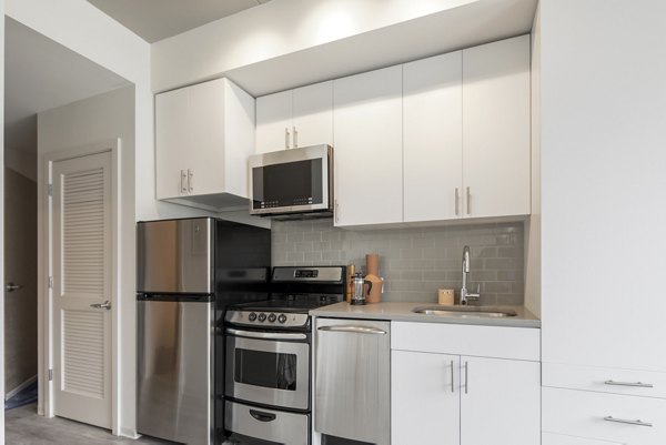 Modern kitchen with stainless steel appliances at The Hamilton I Apartments, luxury living in city center Perfect for culinary creations and gatherings