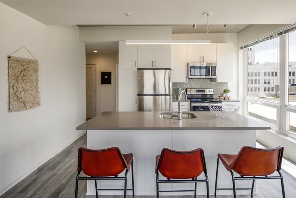 Sleek kitchen with modern appliances at The Hamilton I Apartments