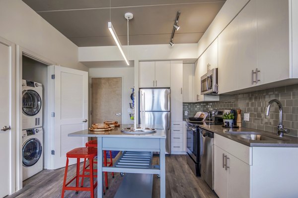 Modern kitchen with stainless steel appliances in The Hamilton I Apartments