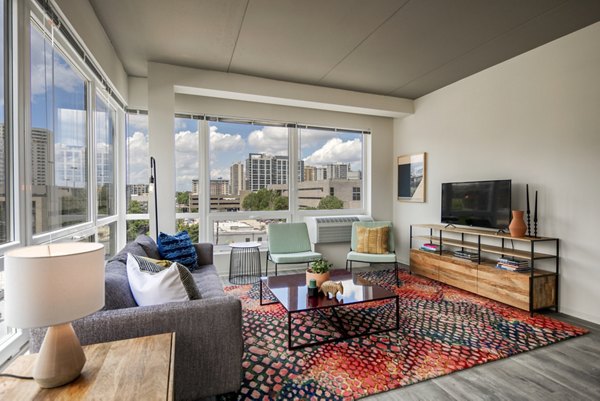 Stylish living room with modern decor and natural light at The Hamilton I Apartments