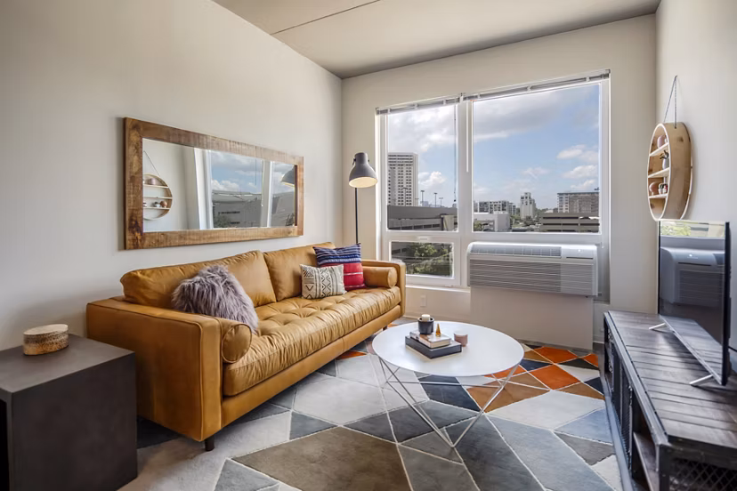 Open-plan living room with modern furnishings at The Hamilton I Apartments